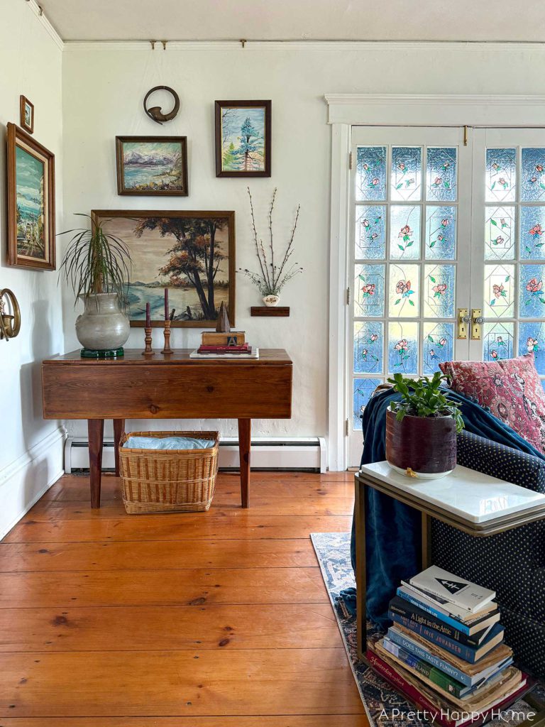 pared down gallery wall gallery wall with a wall pocket wall vase and nature paintings