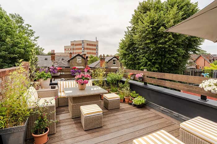 london roof terrace with yellow striped cushions via the nordroom on the happy list