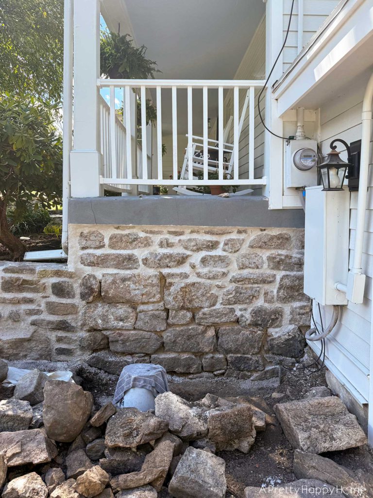 Curved Fieldstone Wall: Part 5, Porch Wall removing concrete skim coat on a stone foundation wall and repointing with lime mortar