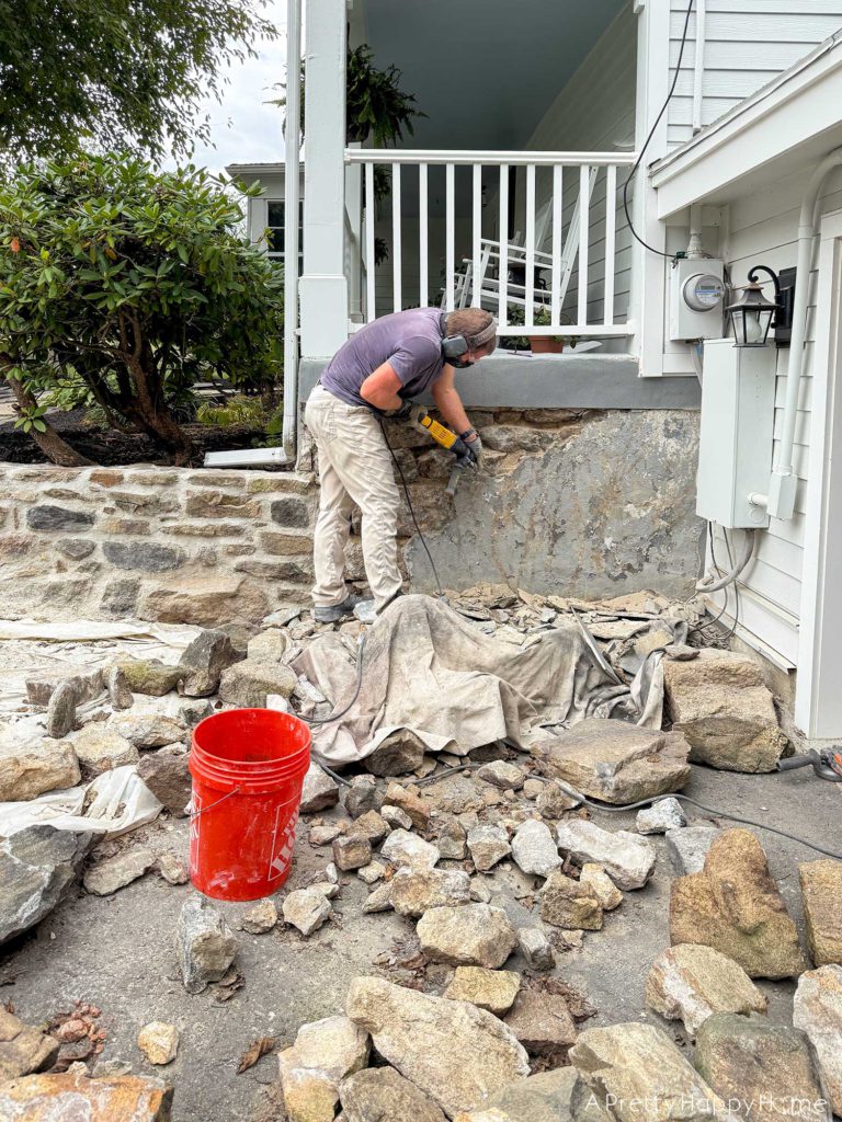 Curved Fieldstone Wall: Part 5, Porch Wall removing concrete skim coat on a stone foundation wall and repointing with lime mortar