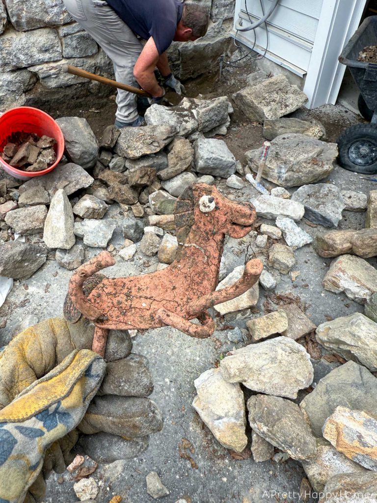 Curved Fieldstone Wall: Part 5, Porch Wall removing concrete skim coat on a stone foundation wall and repointing with lime mortar