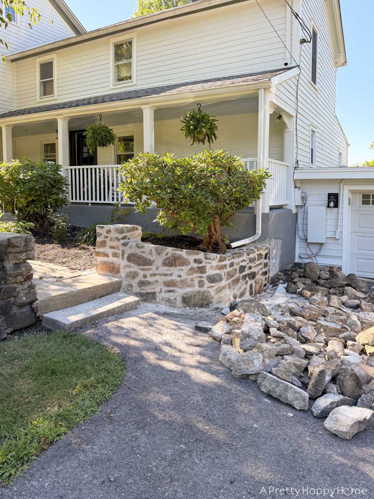 newly rebuilt curved fieldstone wall using lime mortar and natural fieldstone