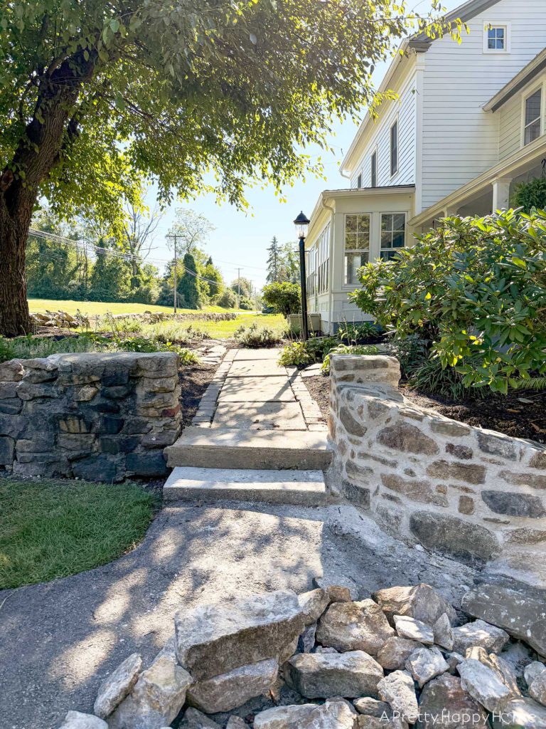 newly rebuilt curved fieldstone wall using lime mortar and natural fieldstone
