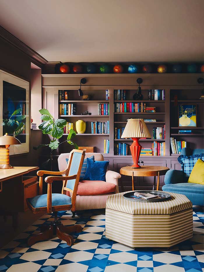 bowling ball collection displayed above a bookcase in oxfordshire home photo by dean hearne for house and garden uk on the happy list