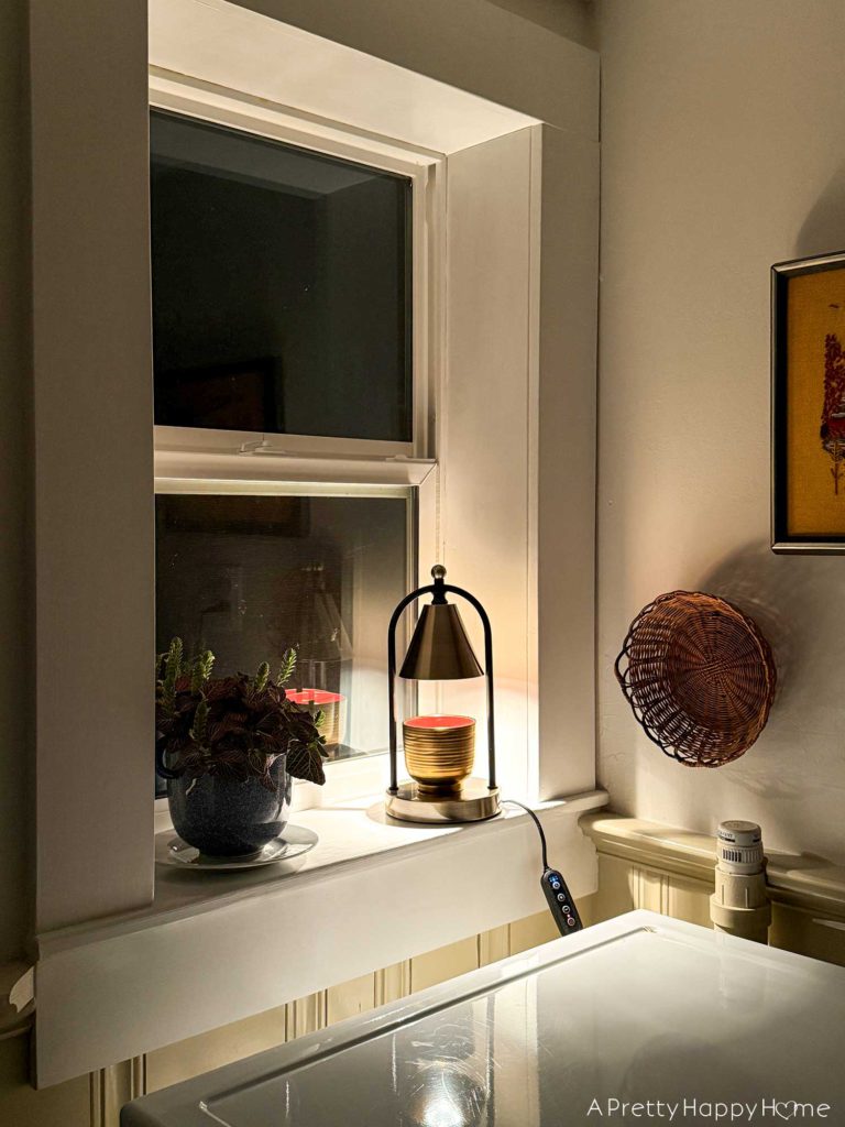 candle warmer lamps candle warmer lamp sitting on a windowsill in a laundry room at night