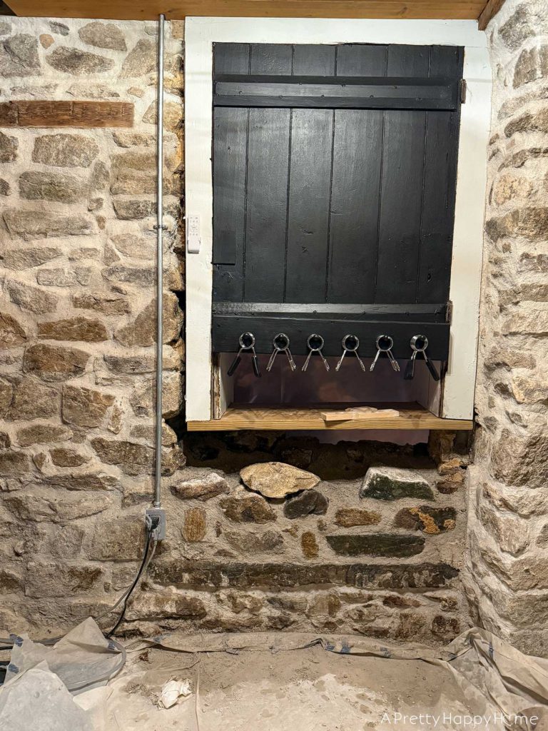 converting a door to a window in a stone building with a stone foundation