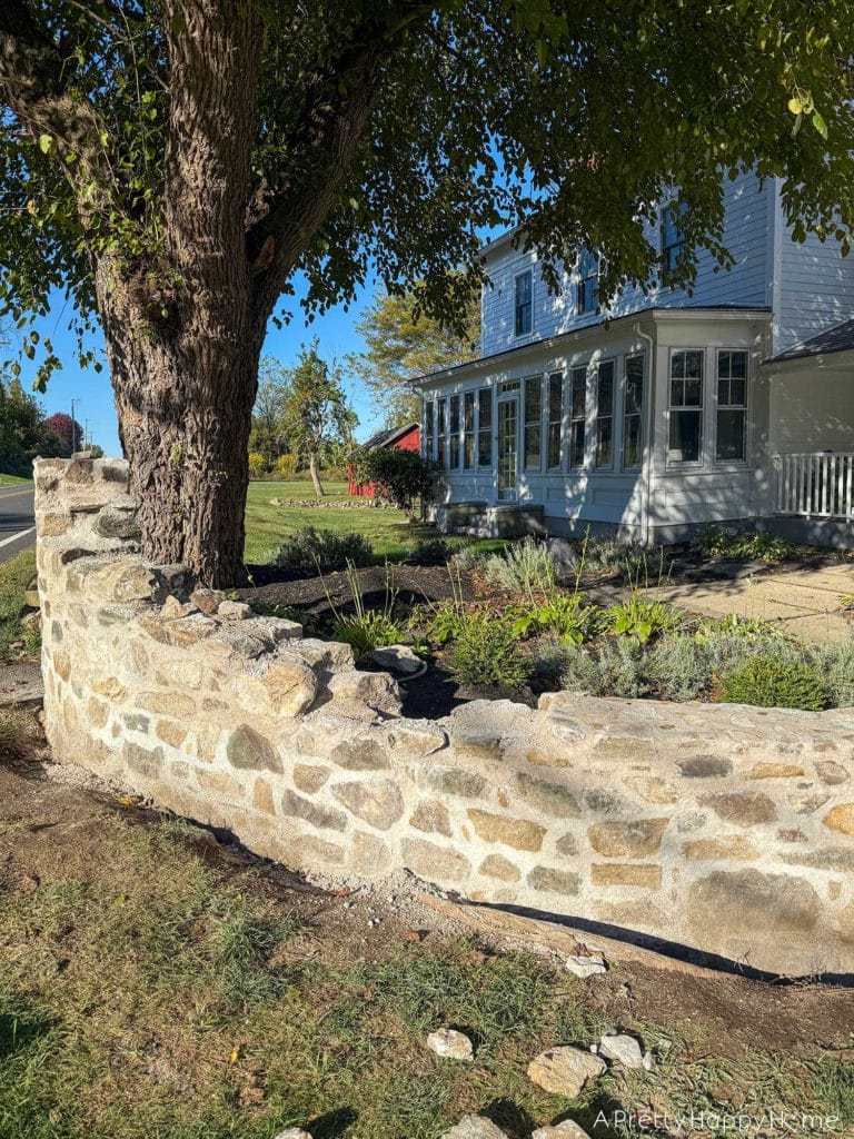 historic masonry DIY curved fieldstone wall adding a swoop and a column built with all natural fieldstone and lime mortar