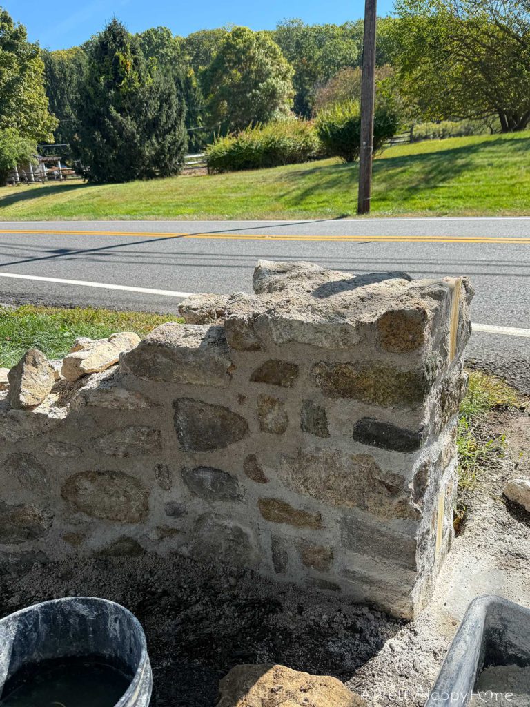 historic masonry DIY curved fieldstone wall adding a swoop and a column built with all natural fieldstone and lime mortar