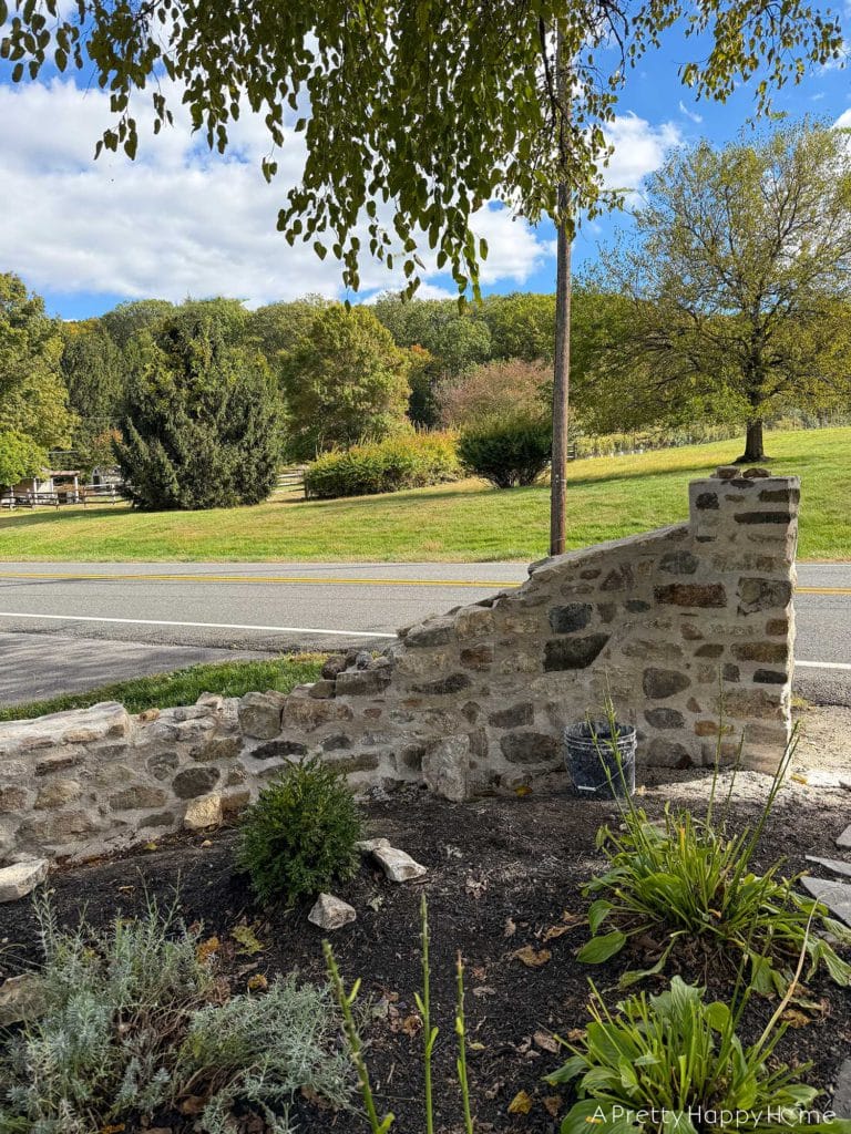 historic masonry DIY curved fieldstone wall adding a swoop and a column built with all natural fieldstone and lime mortar