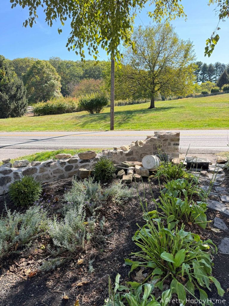 historic masonry DIY curved fieldstone wall adding a swoop and a column built with all natural fieldstone and lime mortar