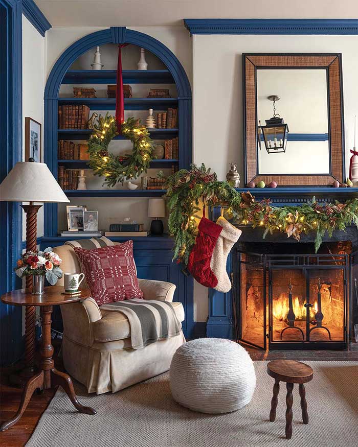 wreath hung in front of blue bookcase in a historic home Photography by Frazier Springfield; Styling by Charlotte Safavi; Interior designs by Corinne Back, Corinne Victoria Design via the cottage journal on the happy list