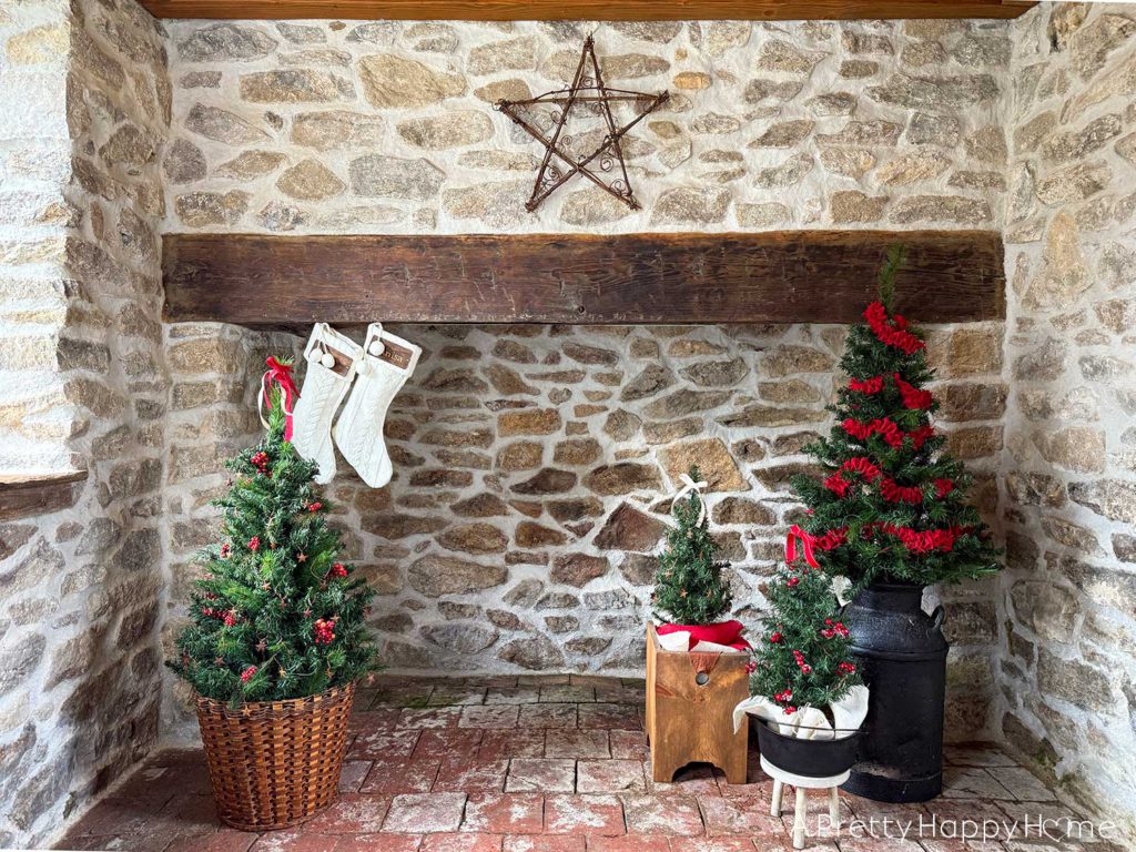 rustic carriage house christmas rustic stone fireplace decorated for christmas using a milkman and a dutch oven as christmas tree stands