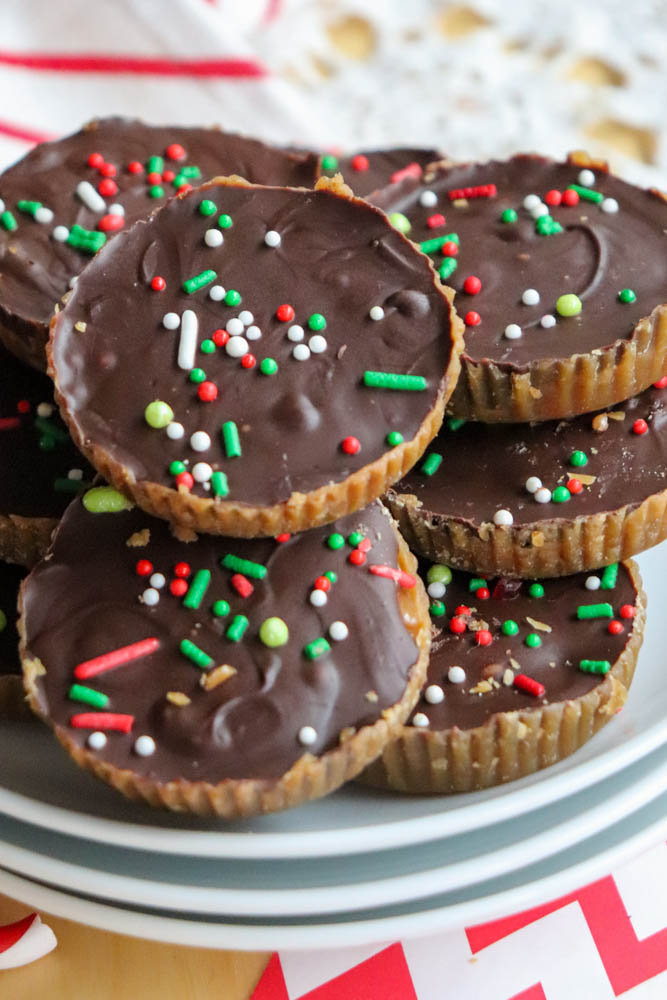 image showing ritz cracker christmas crack cookies which are ritz crackers layered with toffee and melted chocolate. There are red, white, and green sprinkles on top. Recipe by Homemade Heather on the happy list