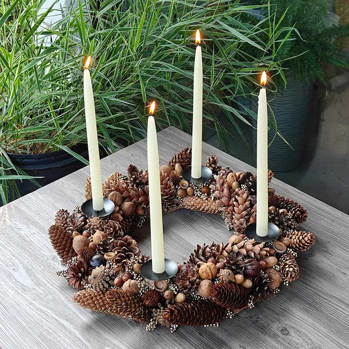 natural tabletop advent wreath made from walnuts, pinecones, acorns, and other natural elements. It has four candles holders and is sold without candles. made by etsy shop KIADEbouquet and featured on the blog post five ways to decorate with nuts for christmas