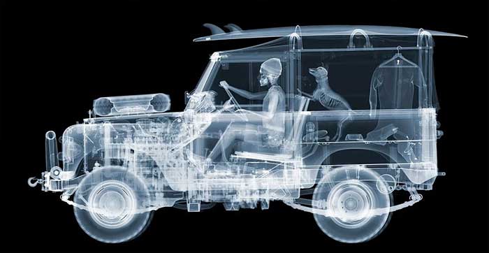 nick veasey's X-ray photo of a jeep with a person and dog inside. There's a surfboard on top of the jeep. available as a print. shown on the happy list.