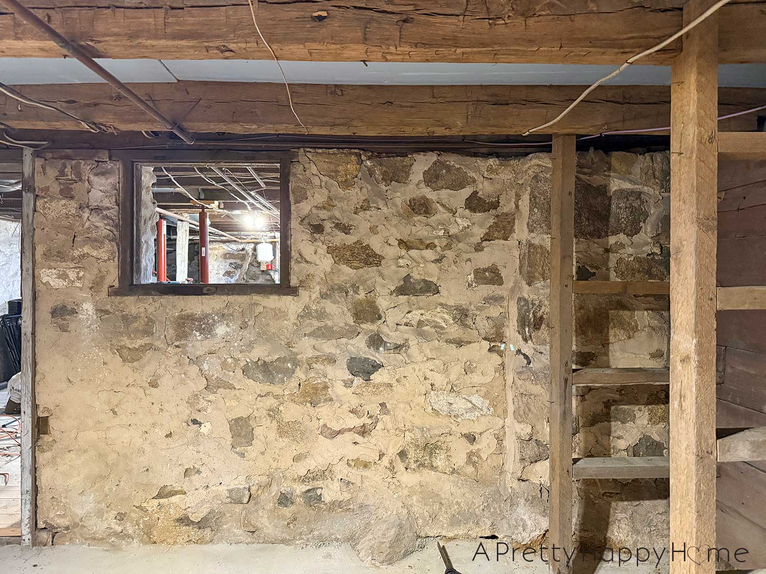 Stone foundation walls in a basement of a 1780s home that desperately need to be repointed and repaired after previous patches with concrete