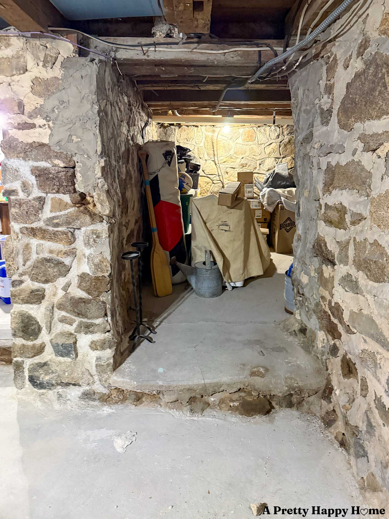 stone foundation showing a poorly constructed opening that is supported by concrete